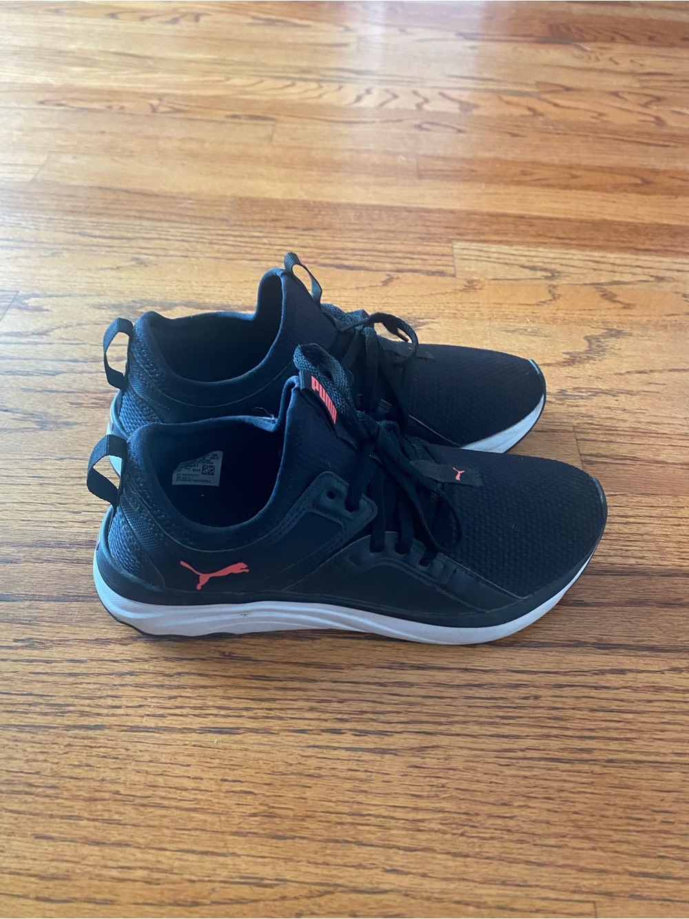 Puma woman’s Black Running Shoes with Coral Accent